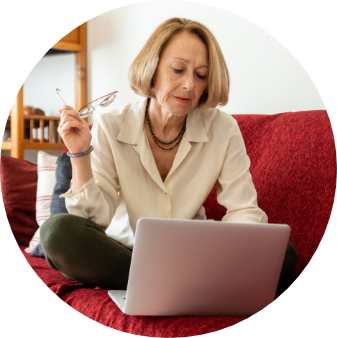 Elegant mature woman using computer at home