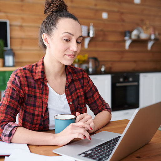 Elegant mature woman using computer at home